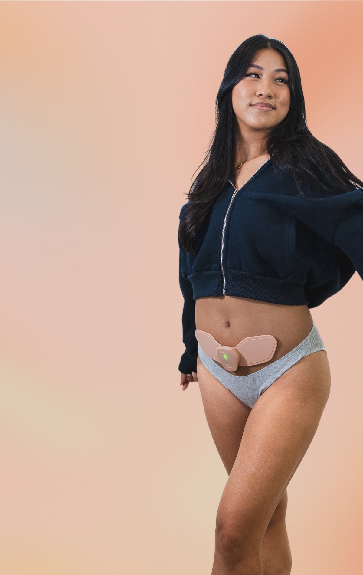 Female Model Using Heat Setting of Sens.U Period Pain Relief Device